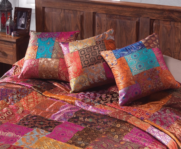 Set Of Brocade Cushions on a Bed
