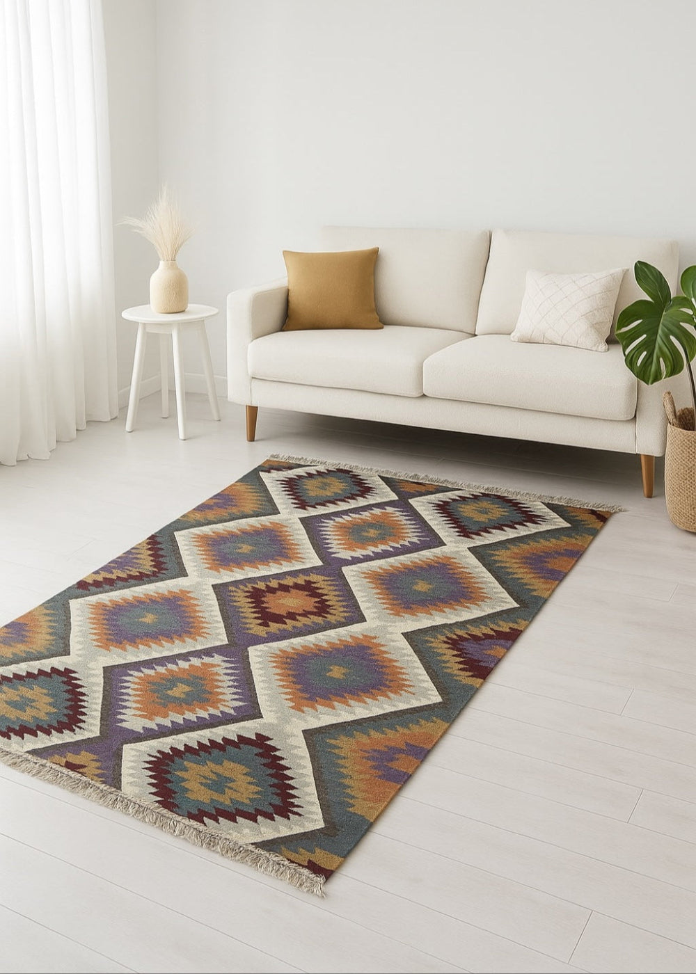 Modern living room with cream sofa and geometric diamond kilim rug in warm earthy tones on light wood flooring.