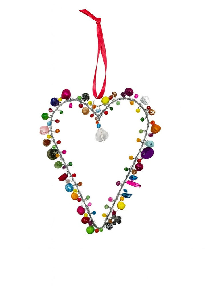 Heart-shaped decorative ornament with colourful beads and a pink ribbon on a white background