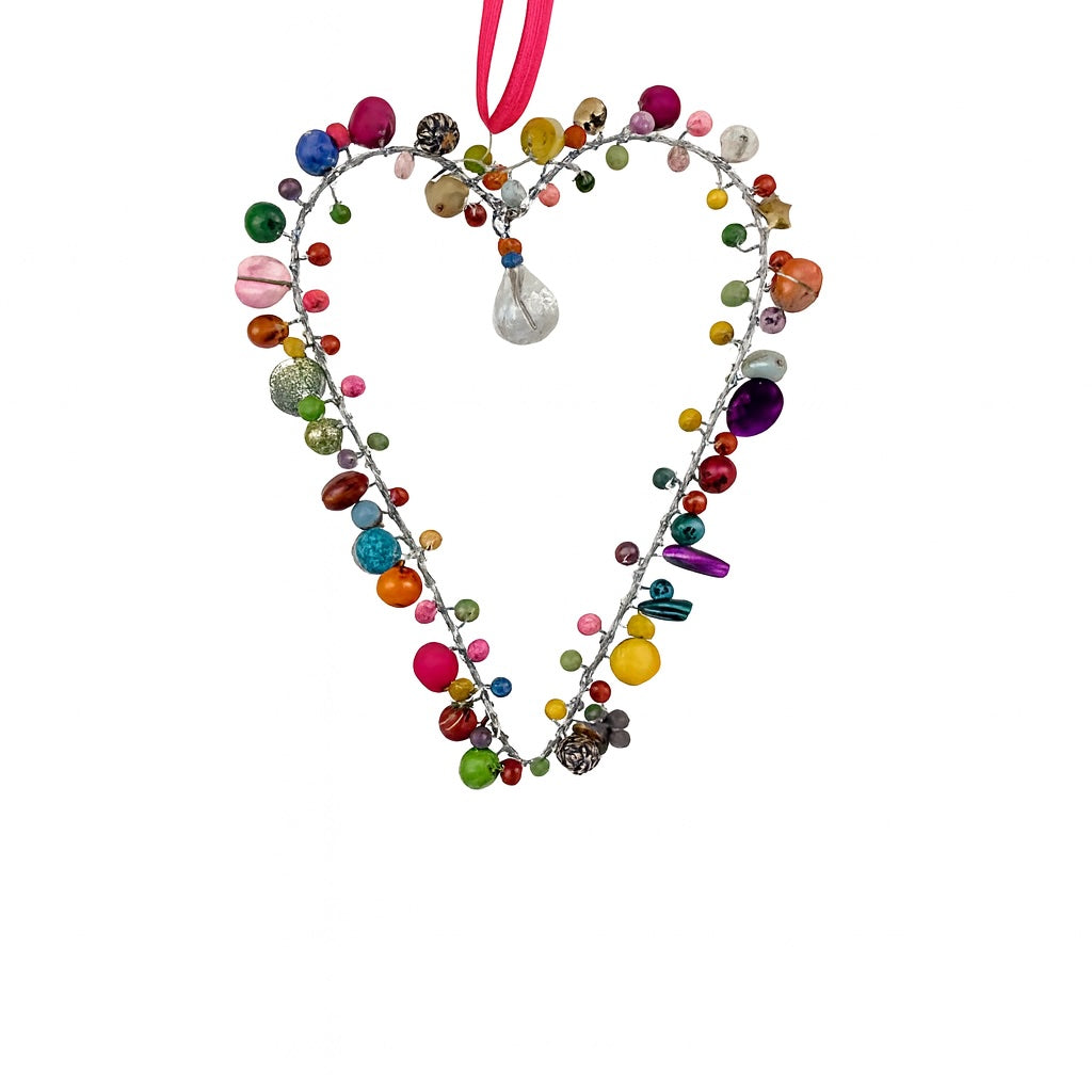Heart-shaped decorative ornament with colourful beads on a white background