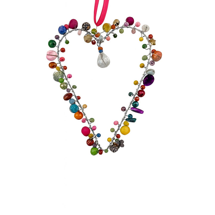 Heart-shaped decorative ornament with colourful beads on a white background