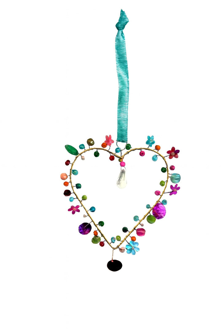 Heart-shaped decoration with colorful beads and a teal ribbon on a white background