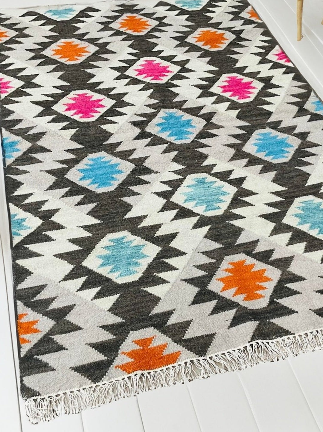 A bright multi colour wool cotton Kilim in a Living Room