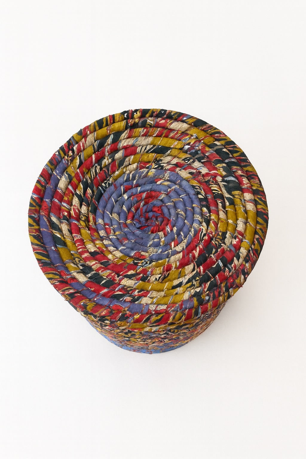 Multicoloured woven basket on a white background