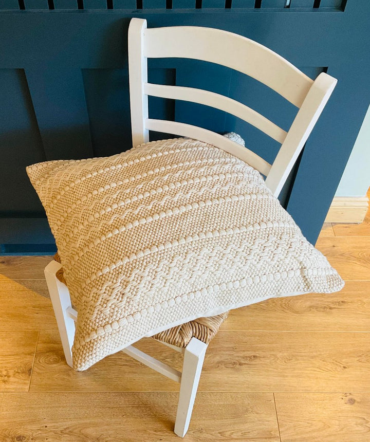 Large Cream Geometric Patterned Cushion On a Chair