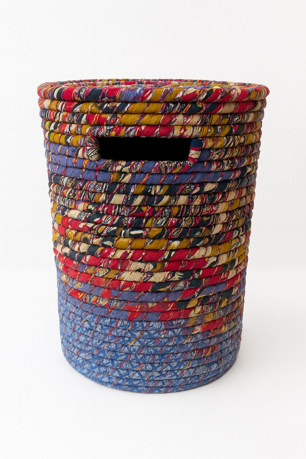 Multicoloured woven basket on a white background