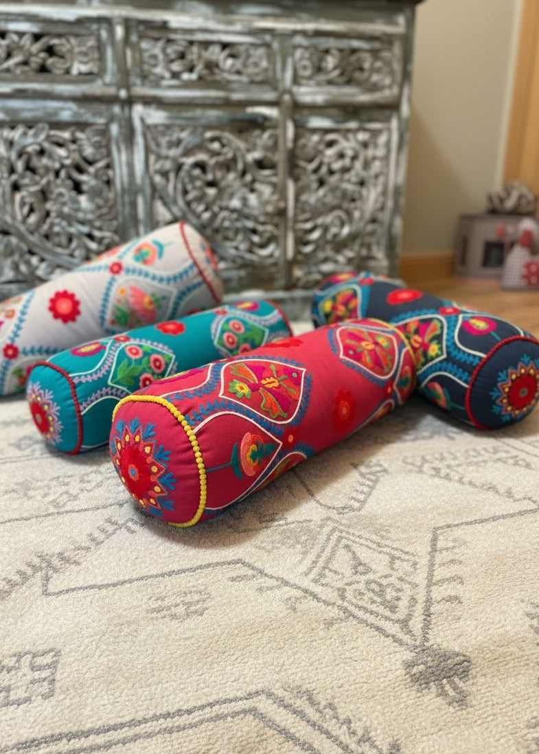 Four Bolster Cushions On a Moroccan Rug