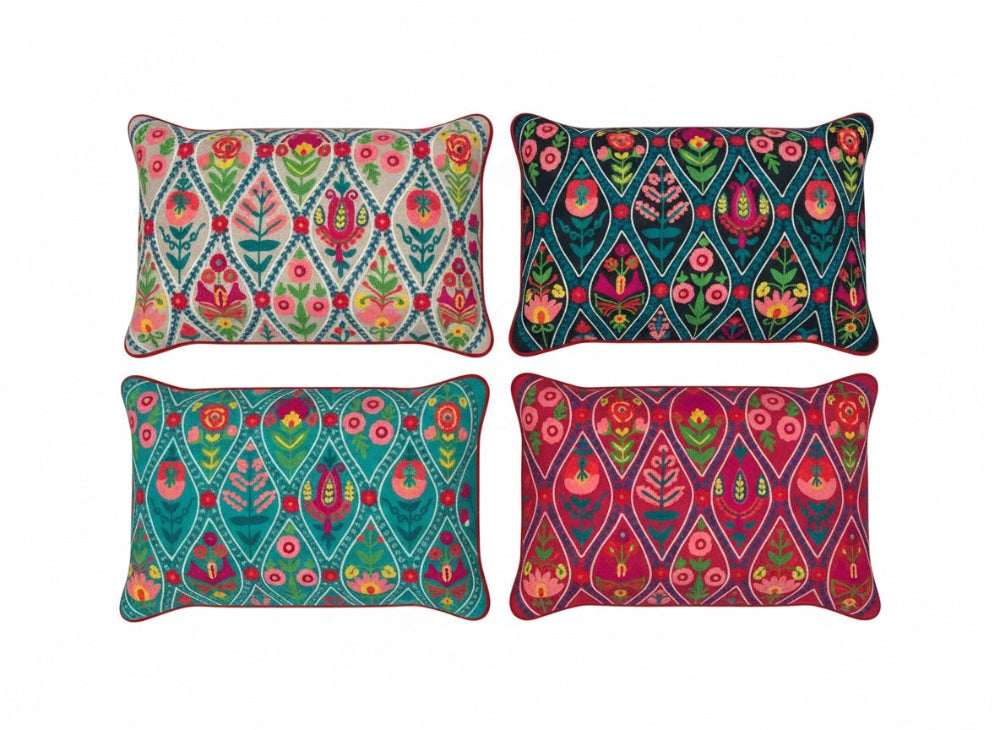Four colourful patterned cotton cushions on a white background