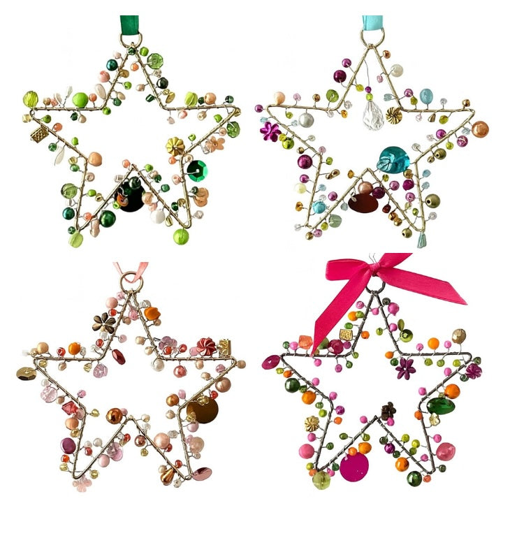 Set of four star-shaped decorative ornaments with beads and ribbons on a white background