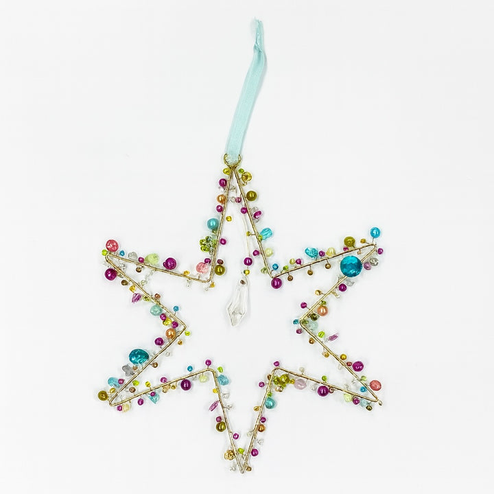 Decorative star ornament with colorful beads on a white background