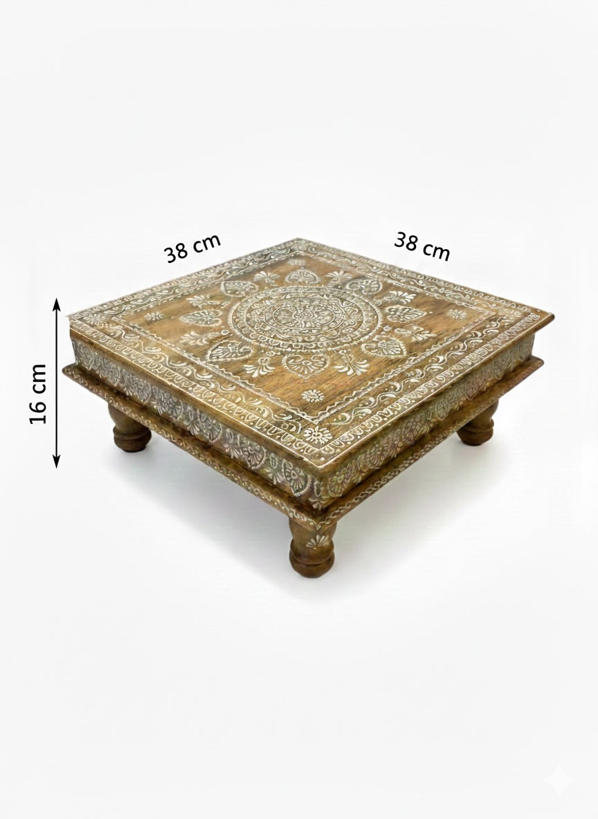 Decorative wooden table with intricate carvings and measurements on a white background