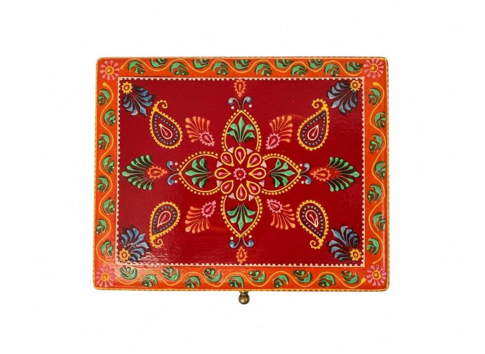 Decorative jewellrey box with colourful patterns on a red background