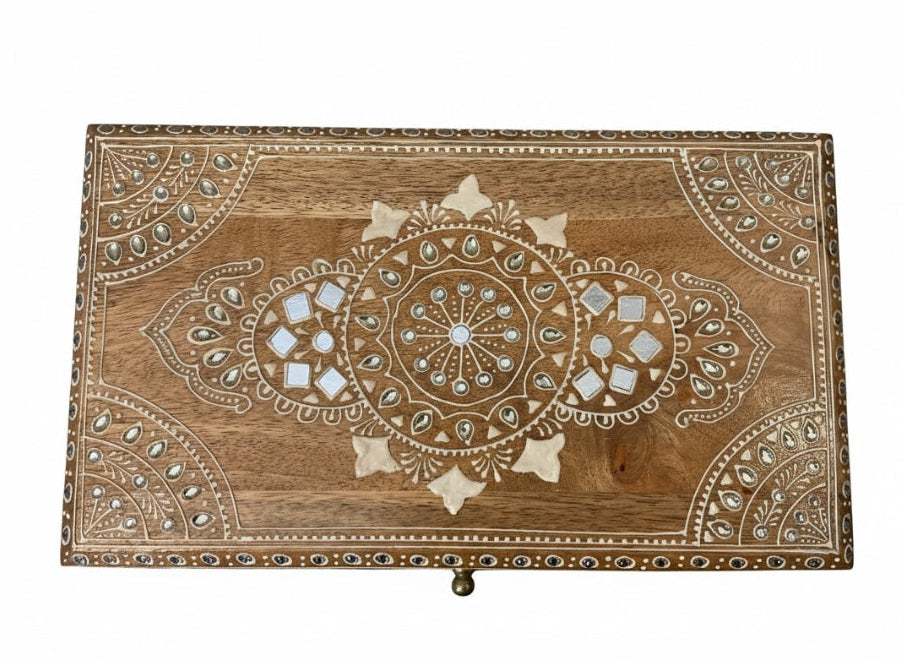 Decorative wooden box with intricate carvings on a white background