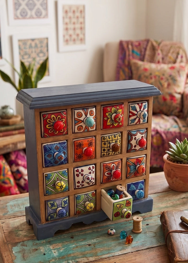 Decorative wooden box with colourful drawers on a rustic table