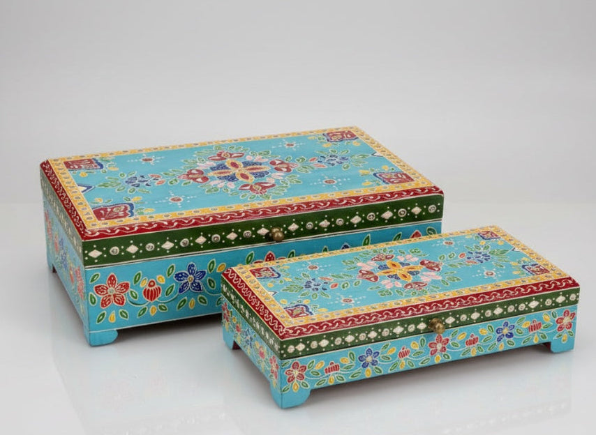 Two decorative boxes with colourful patterns on a white background