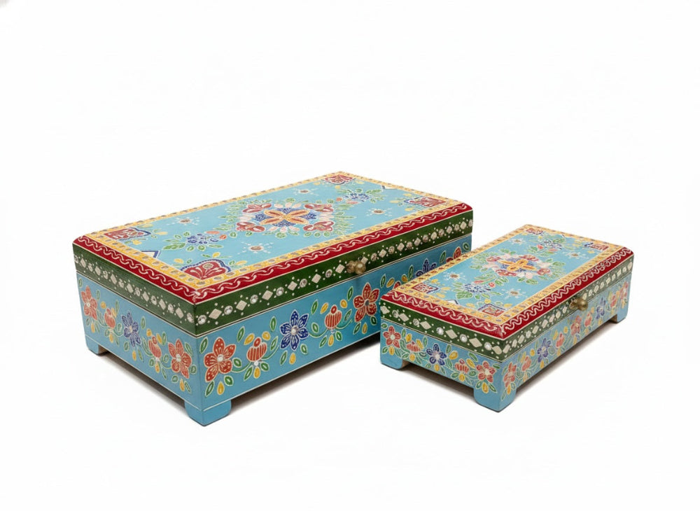 Two colourful floral-patterned storage jewellery boxes on a white background