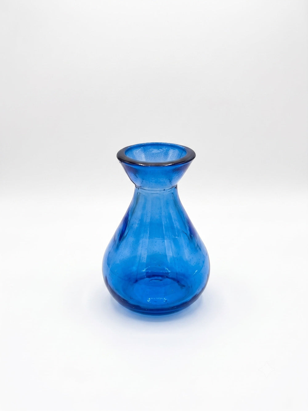 A small blue glass vase with a flared rim and rounded body, photographed on a clean white studio background.