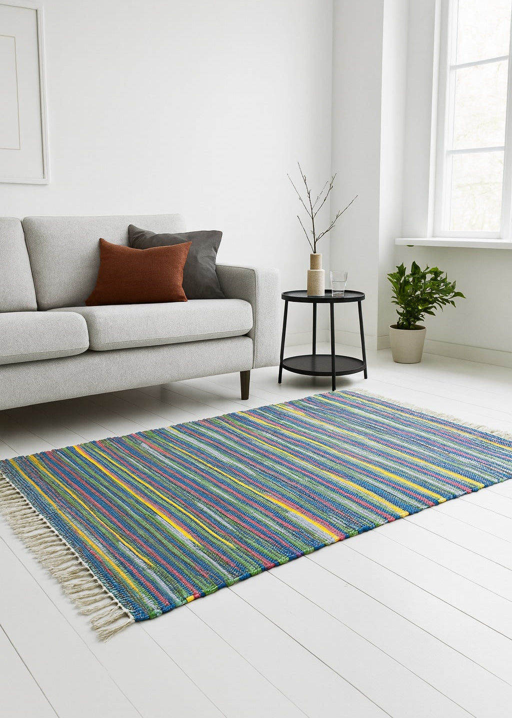 Blue Yellow Rag Rug 120 x 180 cm In a Living Room with Sofa and table.