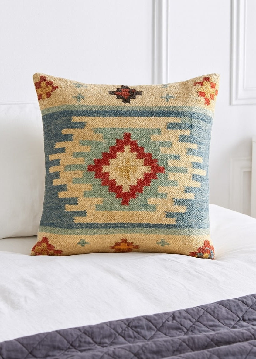 Decorative pillow with geometric pattern on a bed