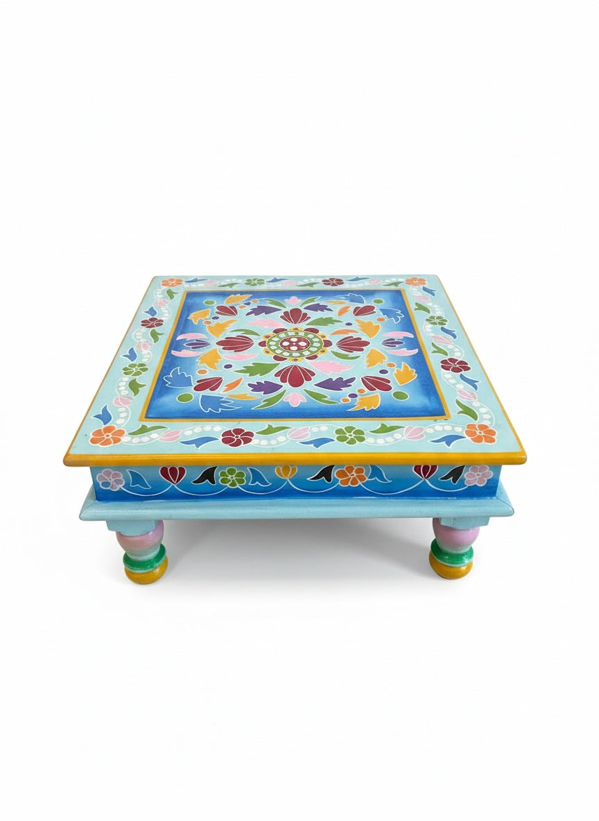 Decorative small table with floral patterns on a white background