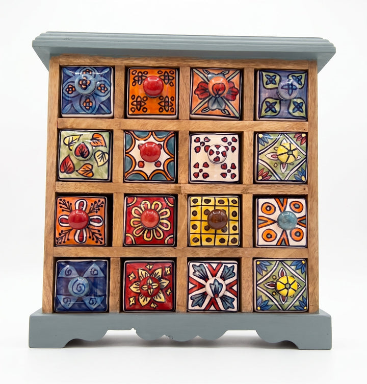 A handcrafted wooden jewellery box with 15 colourful, hand-painted ceramic drawer fronts featuring various traditional Mexican patterns and designs, set against a plain white background.