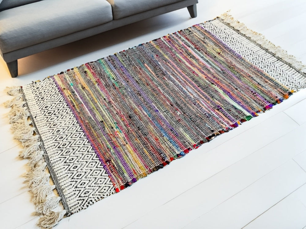 Rag Rug With Tassels on a white wooden floor.
