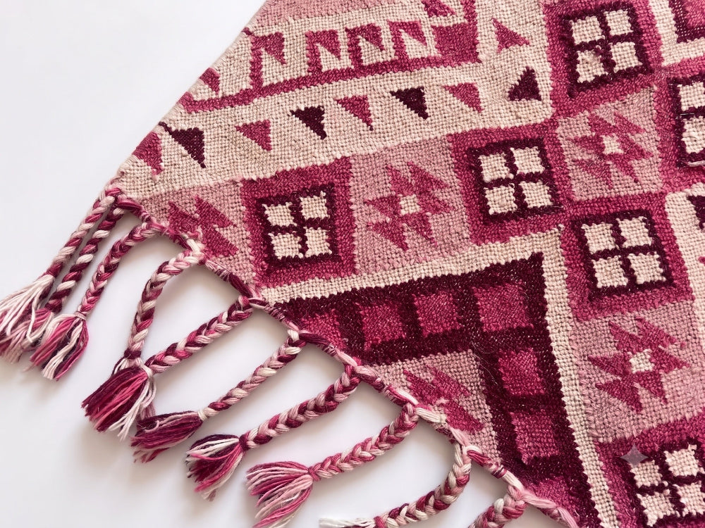 Close Up of Pink Kilim Rug in a white background