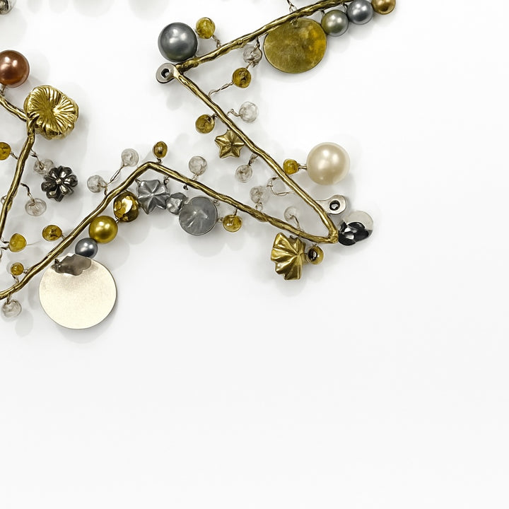 Star Decoration with various beads and charms on a white background