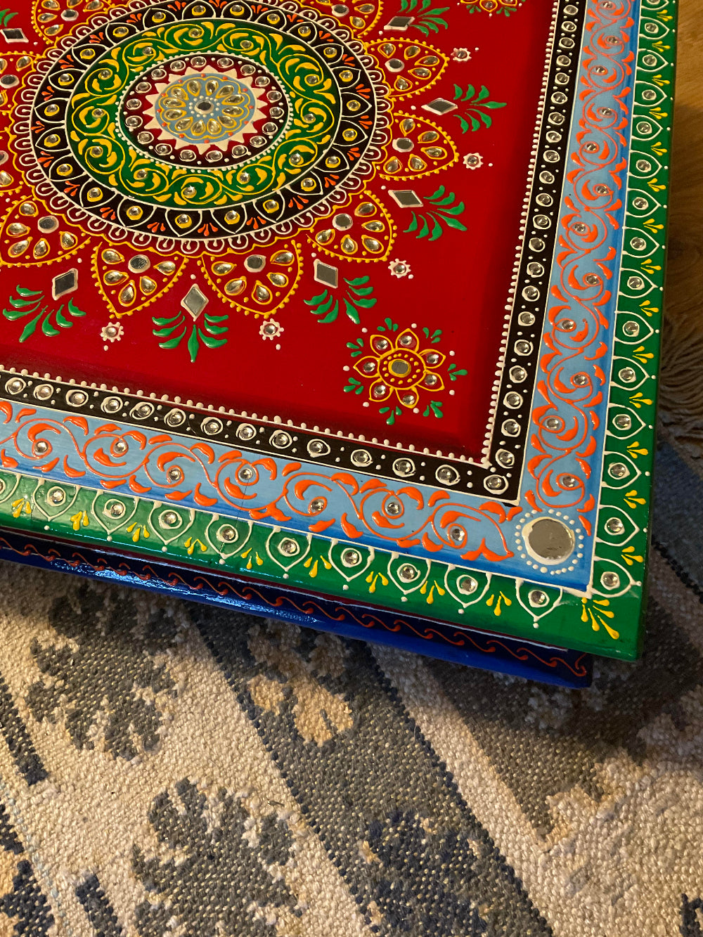 Colorful embroidered fabric with intricate patterns on a textured surface