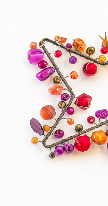 Colourful beaded necklace on a white background