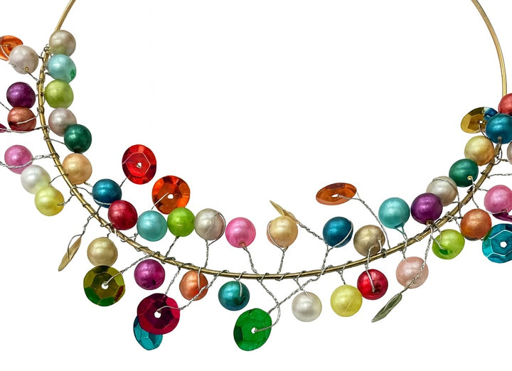 Colourful beaded Round Wire Decoration on a white background