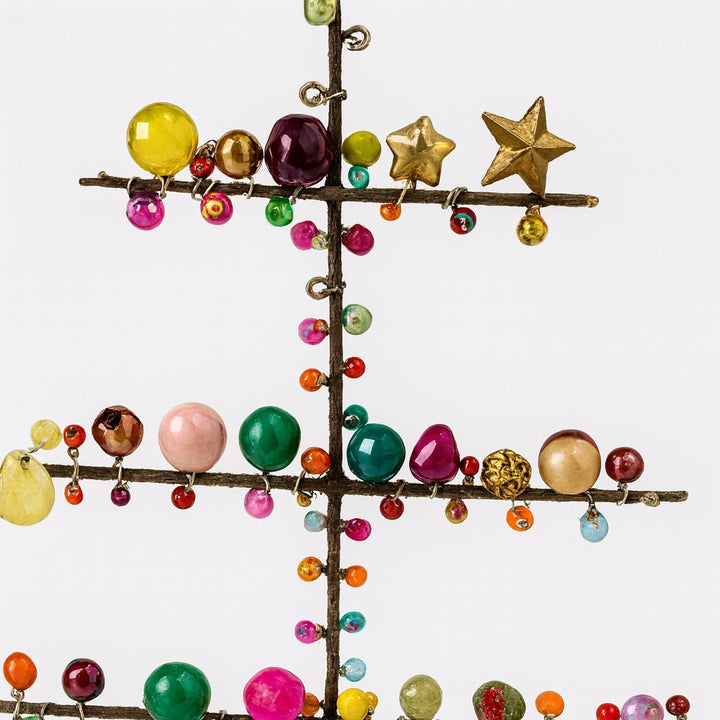 Decorative tree with colourful beads and stars on a white background