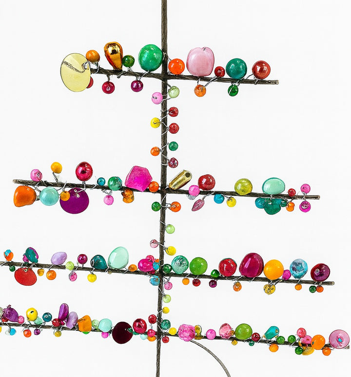 Decorative metal tree with colorful beads on a white background