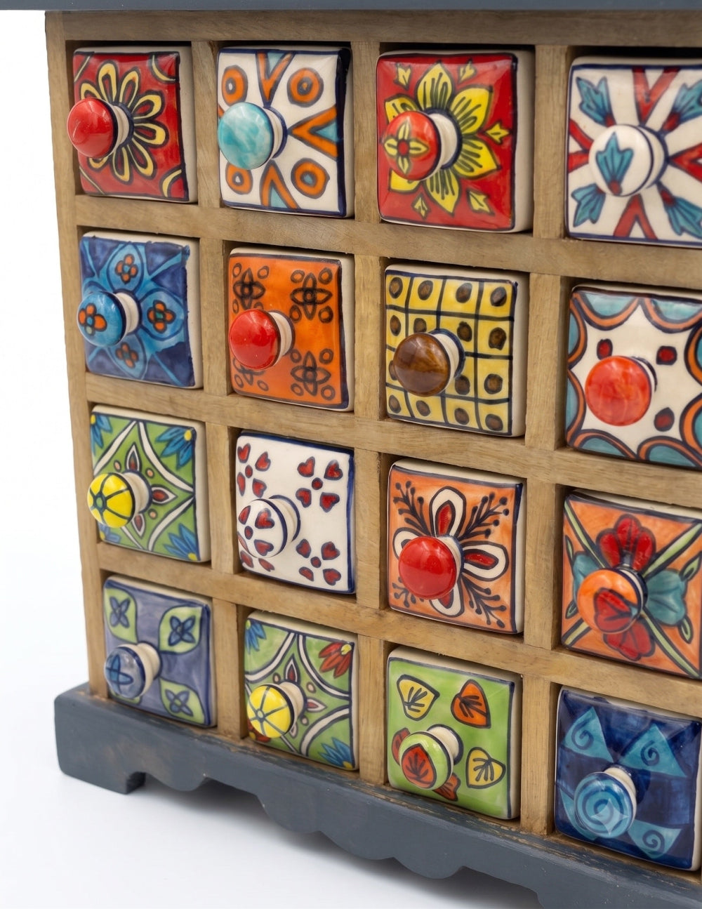 Wooden drawer set with ceramic drawers featuring various patterns and colours.