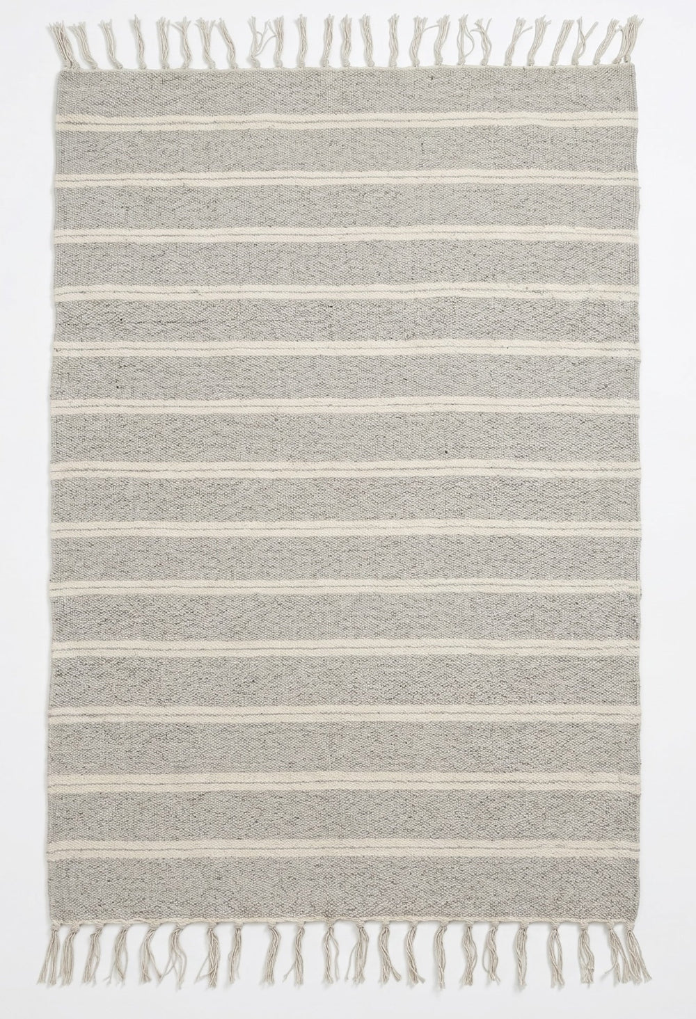 Striped rug with fringes on a white background