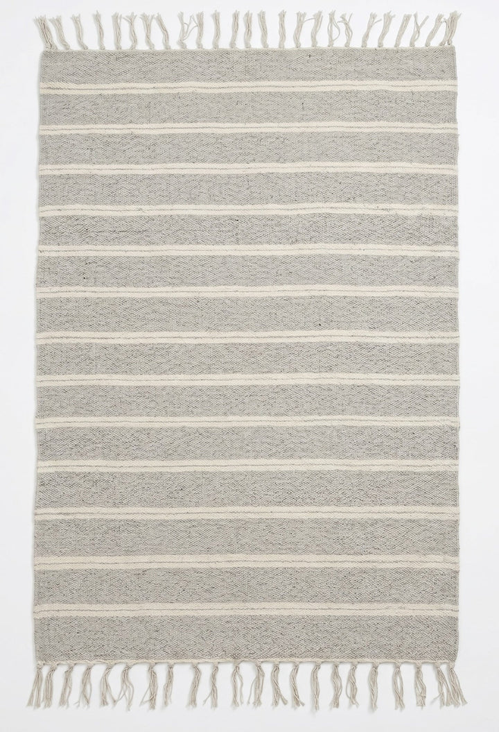 Striped rug with fringes on a white background