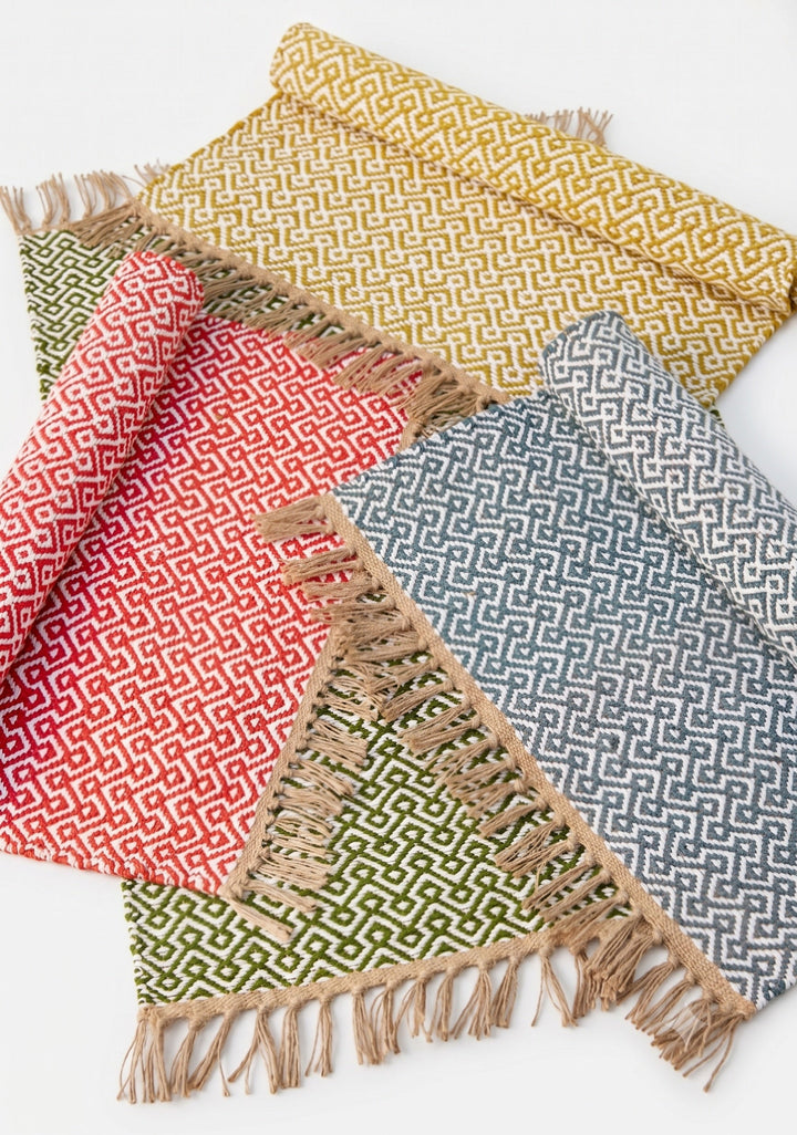 4 Colours of Cotton Jute Rug with geometric pattern in a white background