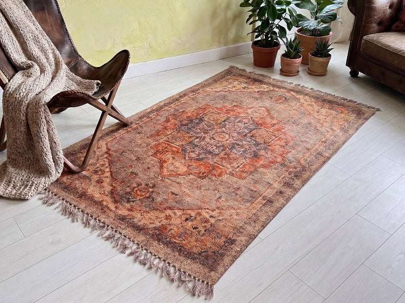 Living room with a patterned rug, wooden chair, and sofa.