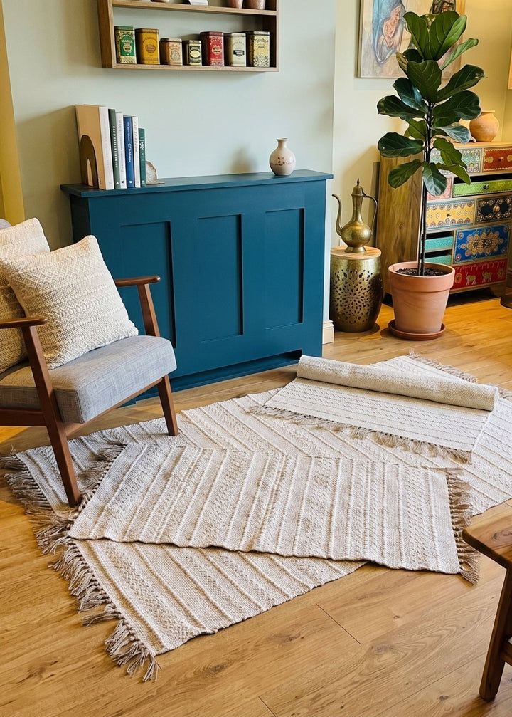 Cream Natural Rugs in a Living room with a blue cabinet, wooden coffee table, and decorative items.
