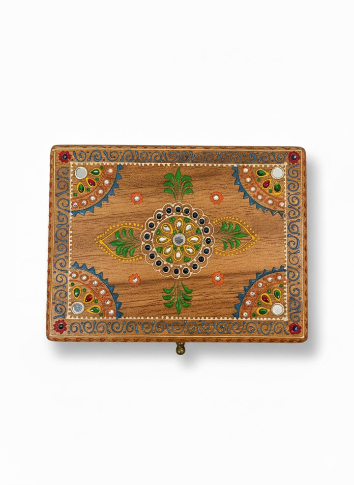 Decorative wooden box with intricate patterns on a white background