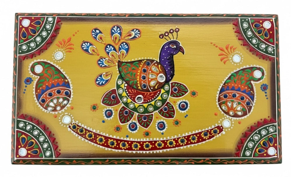 Top of a wooden box showing a peacock design