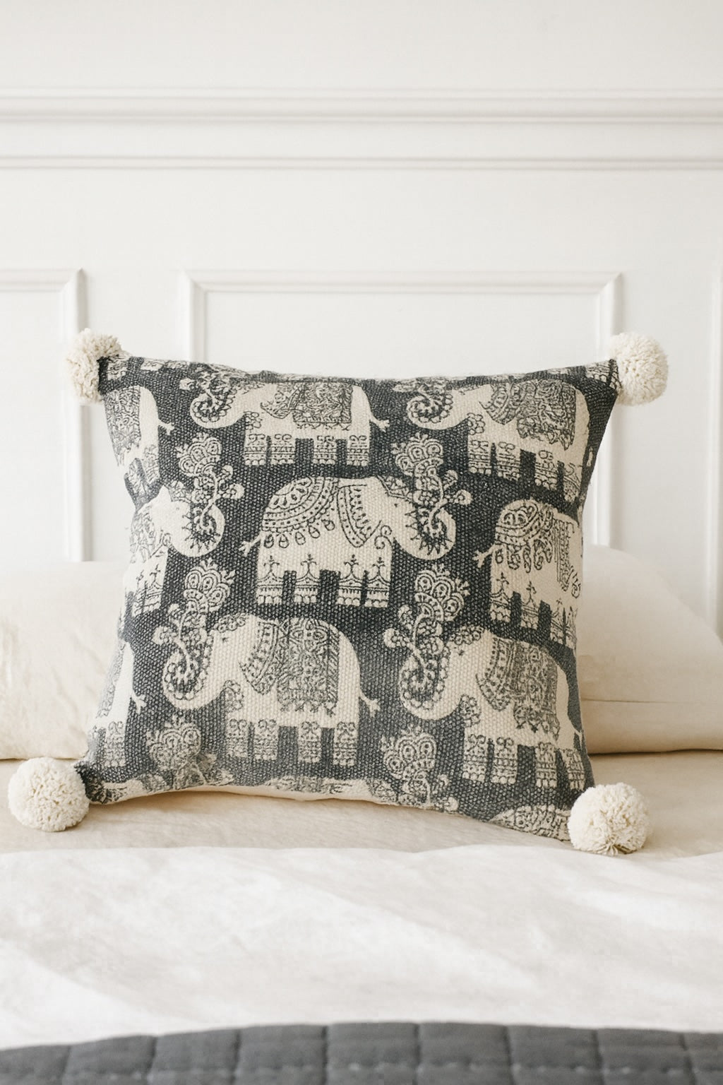Decorative pillow with elephant pattern on a white couch