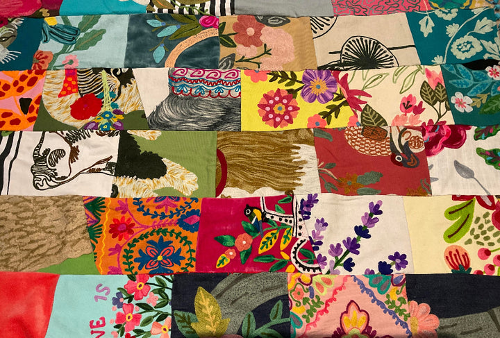 Colorful patchwork quilt with various patterns and colors.