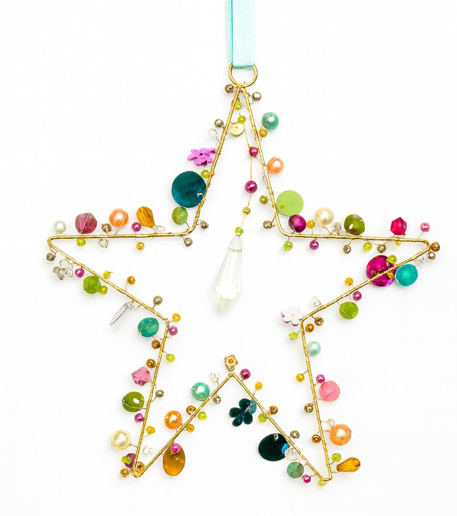 Decorative star ornament with colourful beads and gemstones on a white background