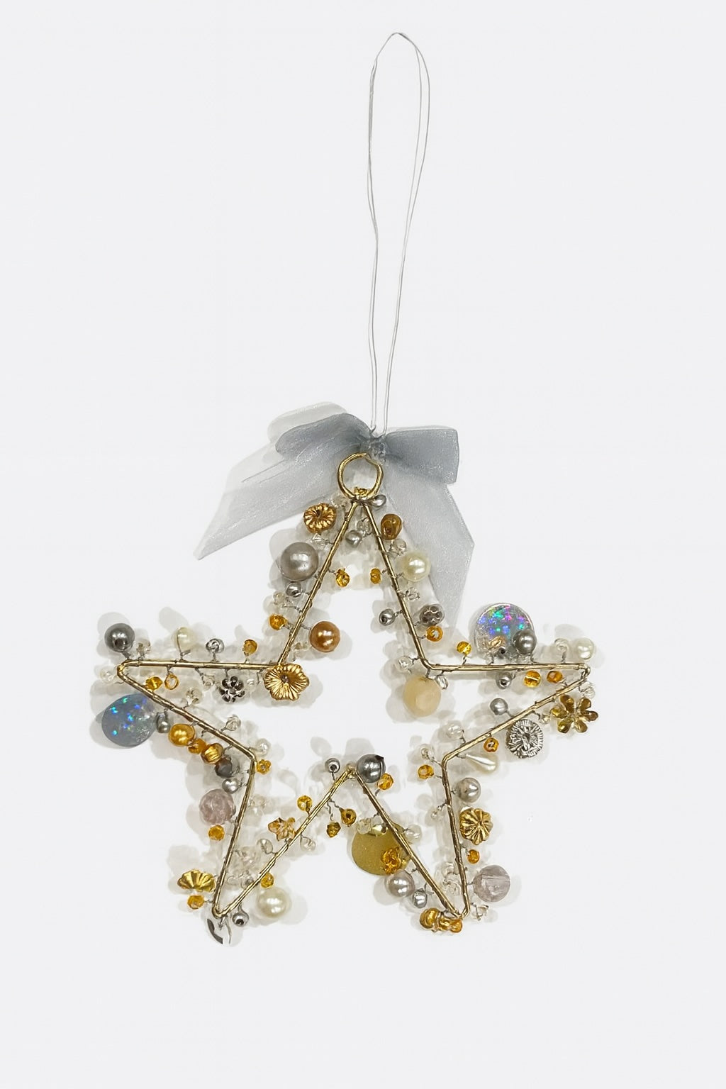 Decorative star ornament with beads and a ribbon on a white background