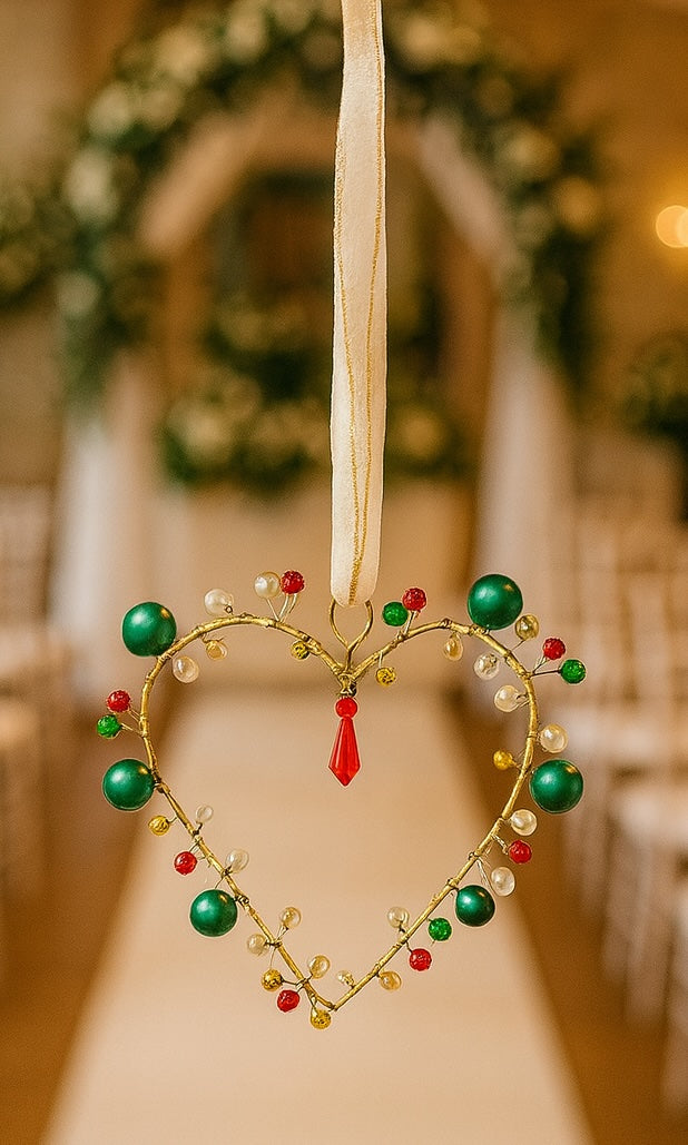 Decorative heart-shaped ornament with beads on a blurred floral background