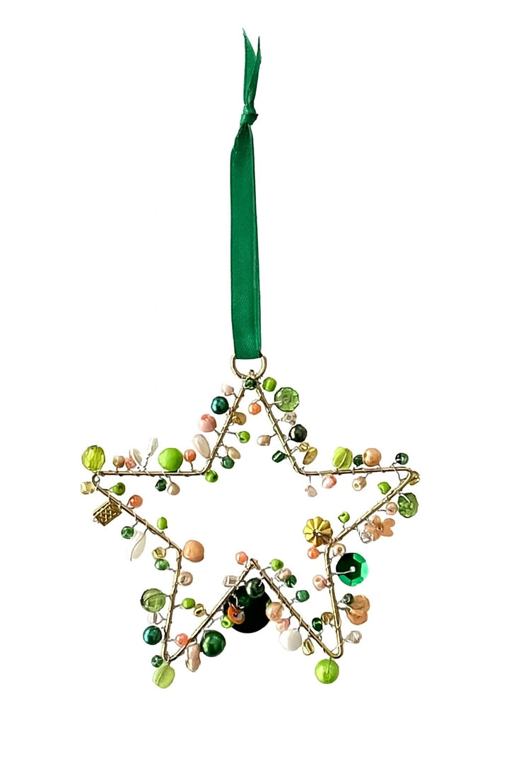 Decorative star ornament with beads and a green ribbon on a white background