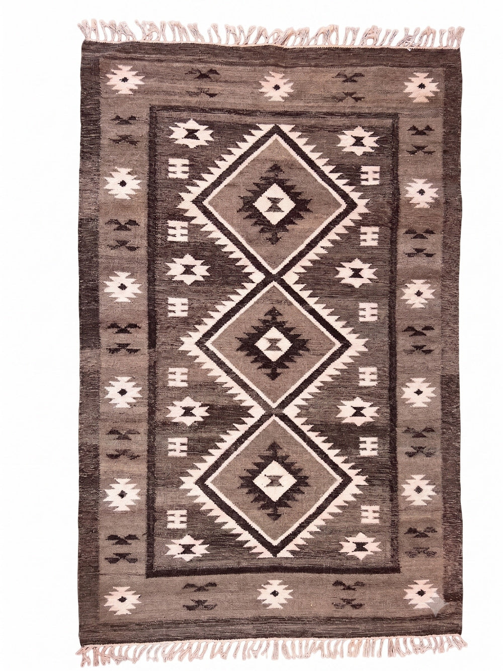 A rectangular woven rug with a Southwestern geometric pattern in shades of brown, beige, and grey, featuring fringed edges.