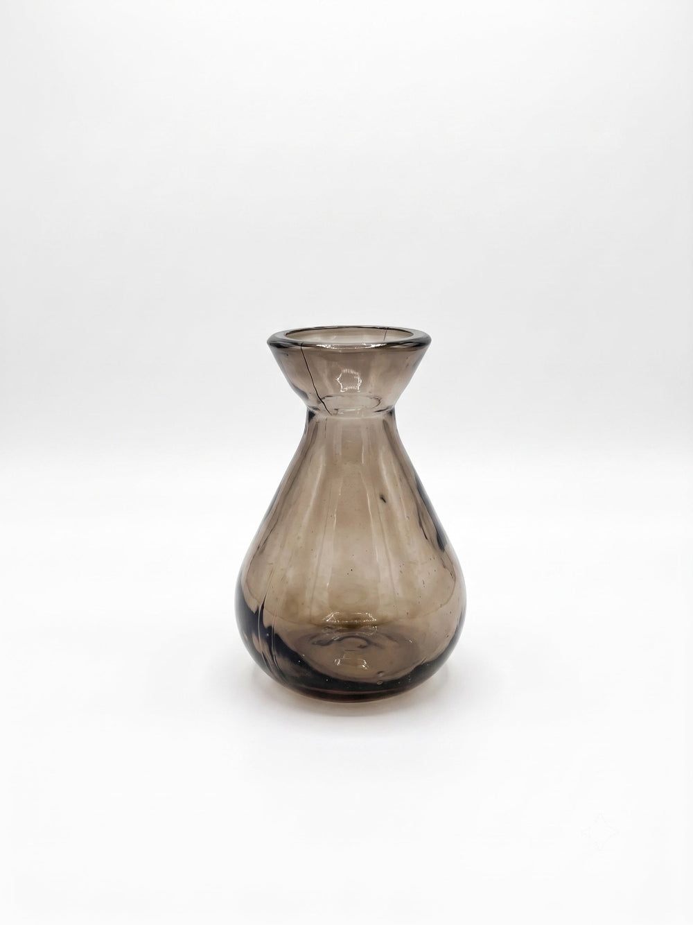 A small translucent smoky grey glass vase with a flared rim and rounded body, photographed on a clean white studio background.