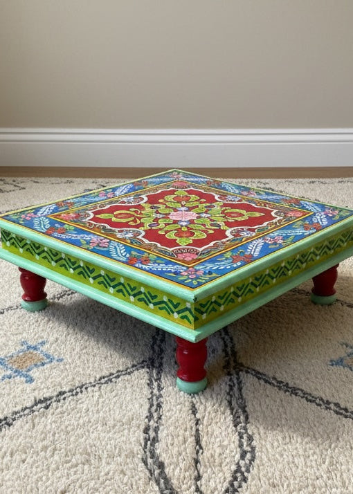 Colorful low table with intricate patterns on a patterned rug